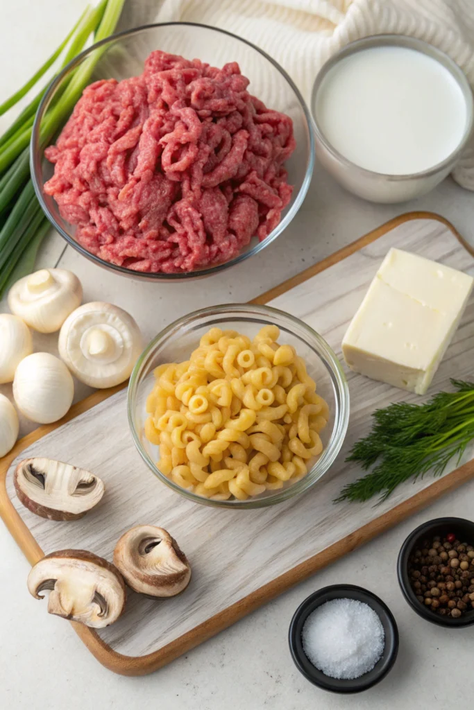 Flat-lay of Hamburger Helper Beef Stroganoff ingredients on a wooden cutting board.